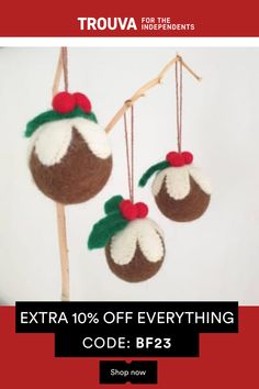 two christmas ornaments hanging from a branch with the text extra 10 % off everything code bp23