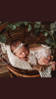 a newborn baby is sleeping in a basket