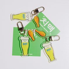 three key chains with beer and sausages on them