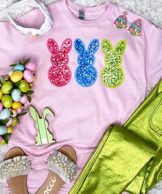 Introducing our "Faux Sequin Bunny Peeps Graphic Shirt," the perfect choice for adding a touch of Easter charm to your wardrobe without the hassle of real sequins. This shirt features a delightful graphic design with faux sequin bunny peeps in pink, blue, and lime, capturing the playful spirit of the holiday.
Please note that this design does not include real sequins, so there is no sparkle, shine, or shimmer. Instead, the faux sequins provide a vibrant and colorful appearance that is perfect for celebrating Easter in style.
Available in sizes ranging from YXS to 5XL, everyone can enjoy the festive charm of this Easter shirt. Whether you're participating in egg hunts, attending family gatherings, or simply spreading holiday cheer, our "Faux Sequin Bunny Peeps Graphic Shirt" is sure to make Casual Pink Sequined T-shirt, Spring T-shirt With Glitter Print, Spring Glitter Tops, Pink Glitter Print Tops For Spring, Bunny Peeps, Easter Shirt, Egg Hunt, Graphic Shirt, Family Gatherings