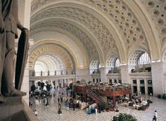 the inside of a building with people walking around