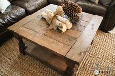 a living room with leather couches and a coffee table in the middle, decorated for christmas