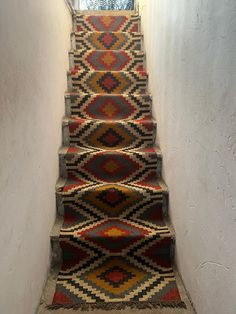 a carpeted staircase leading up to an open window