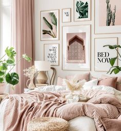 a bedroom with pink walls and pictures on the wall above the bed, along with wicker baskets