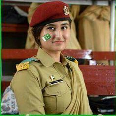 a woman in uniform is posing for the camera with her flag painted on her face