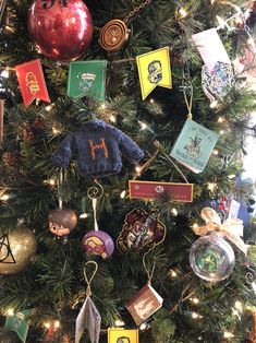 a christmas tree with harry potter themed ornaments on it's branches and decorations hanging from the top