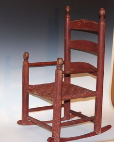 a miniature wooden rocking chair on display