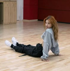 a young woman is sitting on the floor