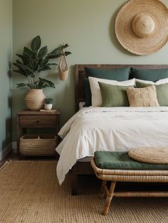 a bedroom with green walls and white bedding, wicker baskets on the wall