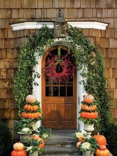 an image of a house with pumpkins on the front door and wreath around it