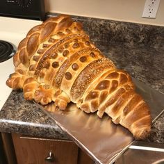 a large loaf of bread sitting on top of a counter next to a stovetop