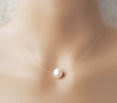 Genuine Cultured Freshwater Pearl Floating Illusion Necklace Stunning and simple will suit all occasions..  9-10mm very good lustre freshwater pearl on good quality jewellery illusion cord with 14ct gold filled clasp The pearls are genuine freshwater pearls therefore each pearl is slightly different in shape and size and each pearls has its own natural unique blemishes.  Will be sent in a organza gift bag All measurements mentioned in this listing is Approximately  Please note the colour of the Clear Pearl Jewelry As A Gift, Pearl Jewelry For Gifts, Clear Pearl Jewelry For Gifts, Necklace Transparent, Illusion Necklace, Floating Pearl Necklace, White Freshwater Pearl, Wedding Jewellery Necklace, Pearl Pendant Necklace