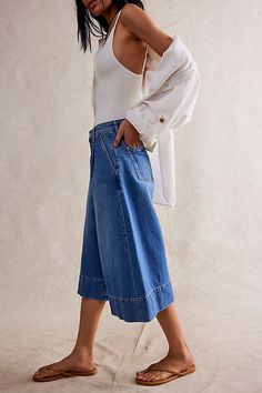 The perfect culotte-inspired pair from our We The Free collection, these jeans are a staple pair for warmer days. **Fit:** Mid-rise, relaxed culotte fit **Features:** Zip fly and button closure, pleating at top, four-pocket design, lightweight rigid denim **Why We ❤ It:** Bold with western boots or off-duty with simple sandals, this pair has endless ways to wear. | We The Free Roma Trouser Crop Jeans at Free People in Medium Wash, Size: 26 Bermuda Shorts Outfit Street Styles, Culotte Outfit, Bermuda Shorts Outfit, Denim Culottes, Cool Clothing, Cloth And Stone, Jeans Outfit Women, Simple Sandals, All Jeans