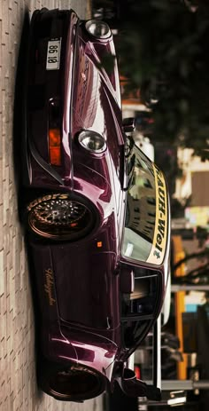 a purple car parked on the side of a building