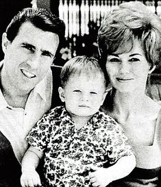 a man, woman and child posing for a photo