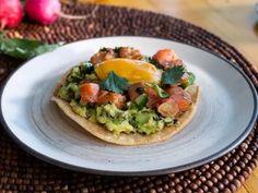 an egg and avocado tostada on a plate