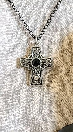 "NECKLACE: Celtic Scroll Cross Necklace with Black and Clear Quartz Crystal Gemstone and Black Inlays.  18\"  Black Steel Chain with Lobster Clasp and 3\" Extension.  Great gift for yourself or someone you Love!❤ SIZE: Charm  L 1\" x W 3/4\" SHIPPING: FREE!❤ ❤Arrives Beautifully Packaged❤ Feels like a gift when opened or is Ready to be gifted, just wrap the box when you receive it.❤ ALL HANDMADE by London Joelle in Loveland, OH Thank you for shopping at Mystika!  Be sure to check out my entire s Black Spiritual Nickel-free Necklace, Nickel-free Black Spiritual Necklaces, Nickel-free Black Spiritual Necklace, Black Adjustable Necklace With Cross Pendant, Black Nickel-free Spiritual Necklaces, Adjustable Black Cross Pendant Necklace, Black Nickel-free Spiritual Necklace, Black Cross Pendant Necklace For Gift, Elegant Black Cross Necklace Gift