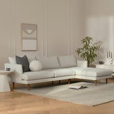 a modern living room with white furniture and wood flooring