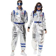 two people in silver space suits with goggles on their heads and one wearing a pair of glasses