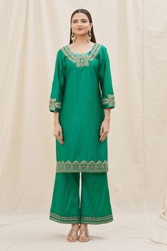 Green kurta with embroidered neckline and cuffs crafted in silk. Comes with flared pant and contrast dupatta.
Components: 3
Pattern: Embroidery
Type Of Work: Sequins, Zari, Thread work
Neckline: Scoop
Sleeve Type: Three quarter
Fabric: Kurta and Pant: Silk, Dupatta: Organza
Color: Green,Peach
Other Details: 
Floral embroidery
Dusty peach dupatta
Occasion: Mehendi and Haldi - Aza Fashions Elegant Festive Palazzo Set With Embroidered Neckline, Festive Kurta With Embroidered Neckline In Cotton Silk, Festive Cotton Silk Kurta With Embroidered Neckline, Eid Long Sleeve Sets With Embroidered Neckline, Eid Sets With Embroidered Neckline And Long Sleeves, Long Sleeve Sets With Embroidered Neckline For Eid, Chanderi Straight Kurta Set With Embroidered Neckline, Traditional Salwar Kameez With Embroidered Neckline, Traditional Salwar Kameez With Embroidered Neckline For Festive Occasions