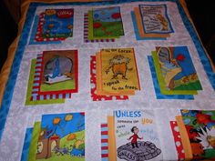 a child's quilt with dr seuss and the cat in the hat on it