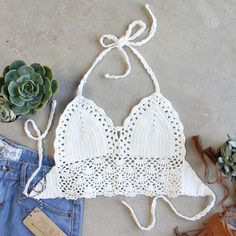 A must-have for any boho boutique. Gorgeous white crochet adorns this darling top. Designed with a soft loop crochet, this top has a tie back & neck, lined cup, and darling scalloped edges. One size for small, medium, & large. Custom made to order. Please allow 2 weeks for production. Color: White 60% cotton & 40% rayon Imported Hand Wash Cold split One size for S,M, & L Bust 32-38 Waist - Hips - Length - Bust, waist, and hip measurements are a total circumference. Length is meas Woodstock Crochet, Loop Crochet, White Summer Tops, Lace Blouses, Fringe Crop Top, Crochet Boho Top, Crochet Bra, Boho Boutique, Festival Tops