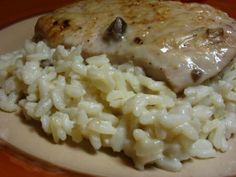 chicken and rice with gravy on a plate