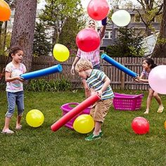 children playing with balloons in the yard