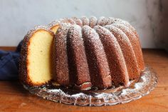 a bundt cake with one slice cut out on a glass plate next to it