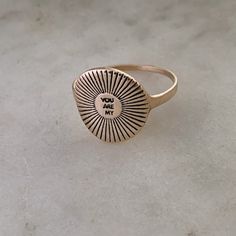 Buy in 14K Gold. A sweet and sunny hand-stamped ring! This ring measures approximately 3/4" in diameter. Not sure about your ring size? Order a ring sizer here! Shop MIMOSA's You Are My Sunshine Collection. Made by hand in our South Louisiana studio.Each piece varies slightly due to its handmade nature. *Note: Sterling Silver and 14K Gold prices may vary due to fluctuation in the gold and silver markets. Yellow Gold 14k Stamped Signet Ring, Elegant Yellow Gold Signet Ring Stamped 14k, Gold Plated Signet Ring Stamped 14k, Gold Celestial Signet Ring Stamped 14k, You Are My Sunshine Jewelry, Silver Market, Heart Shaped Candy, Stamped Ring, Sunshine Necklace