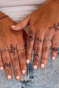 two hands with different tattoos on them