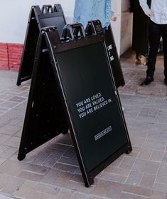 a sign that says you are loved, you are not afraid to ask in front of a building