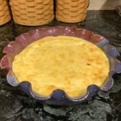 an uncooked pie sitting on top of a table next to stacks of cookies