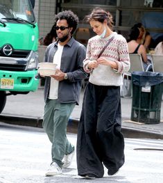 a man and woman walking down the street