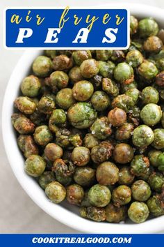 a white bowl filled with green sprouts on top of a blue and white sign