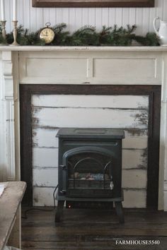 an old fashioned fireplace with a clock above it