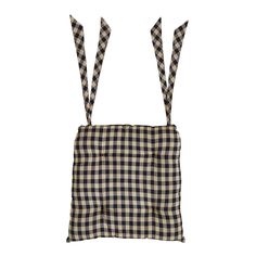 a black and white checkered bag with two ties hanging from it's sides