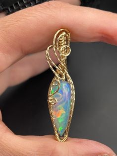 This beautiful Ethiopian Opal gold filled pendant is about 1 1/4 inches tall and 1/2" wide, it includes a 18" gold filled necklace and in a gift box, ready for gifting! These are not costume pieces that will chip away or rust over time. They will last forever if taken care of, which is why I include a free polishing cloth with every order.  All of my pieces are made with high quality wire from Rio Grande. Quality is very important to me! Message me, If you have any questions, I'm happy to help. Wire Wrapped Round Pendant Jewelry As Gift, Wire Wrapped Pendant Jewelry Gift, Wire Wrapped Pendant Jewelry For Gifts, 14k Gold Large Pendant Jewelry Gift, 14k Gold Jewelry With Large Pendant For Gift, Spiritual Pendant Jewelry For Birthday Gift, Hand Wrapped Round Pendant Jewelry As Gift, Unique Hand Wrapped Oval Pendant Jewelry, Artisan Yellow Gold Jewelry Gift