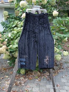 1997 Velvet Cosmos Pant Primitive Ram Obsidian Size 2 displayed on a clothes rack, showcasing its flowy design with a full two-inch elastic waistband and suggestively painted lowers. Velvet Knit, Fish Clothing, True Winter, Blue Fish, Apron Dress, Fishing Outfits, Dress Pant, Winter Holiday, Knit Cotton