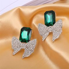 Bring some sparkle to your ears with this pair of silver-plated drop earrings featuring crystals and cubic zirconia. 1.3" W x 1.5" L Silver-plated copper / cubic zirconia / crystal Green Crystal, Green Crystals, Silver Plate, Silver Plated, Cubic Zirconia, Copper, Sparkle, Plating, Drop Earrings