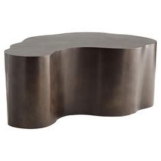 an oval shaped metal table with a curved design on the top and bottom, shown in bronze