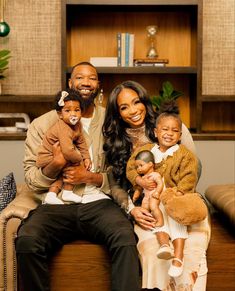 the couple and their children are posing for a family photo