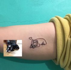 a small dog tattoo on the left arm and an image of a black and white dog