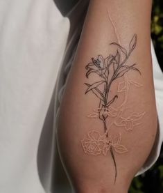 a woman's arm with flowers on it