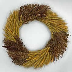 a dried wreath with yellow and brown stems on a white background, ready to be used as an ornament