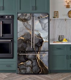 a kitchen with green cabinets, marble counter tops and stainless steel appliances in the center