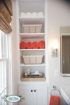 the bathroom is clean and ready to be used as a storage area for towels or other items