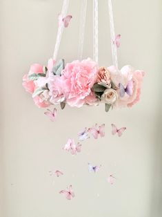 a mobile with flowers and butterflies hanging from it