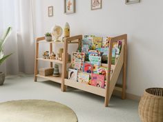 a child's bookshelf in the corner of a room with pictures on the wall