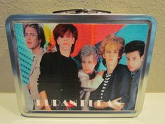 a metal lunch box with an image of the backs on it